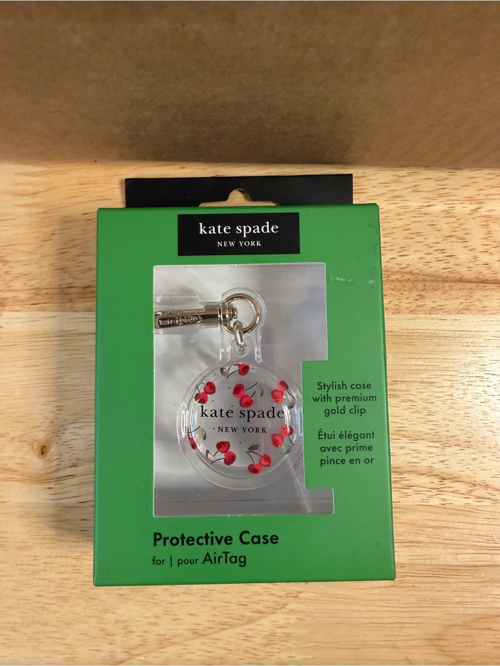 kate spade Clear AirTag Case with Red Cherry Print and Gold Clip